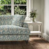 Sofa covered in a jolly printed linen fabric in blue, black and cream