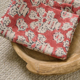 A jolly printed linen fabric in red, black and cream