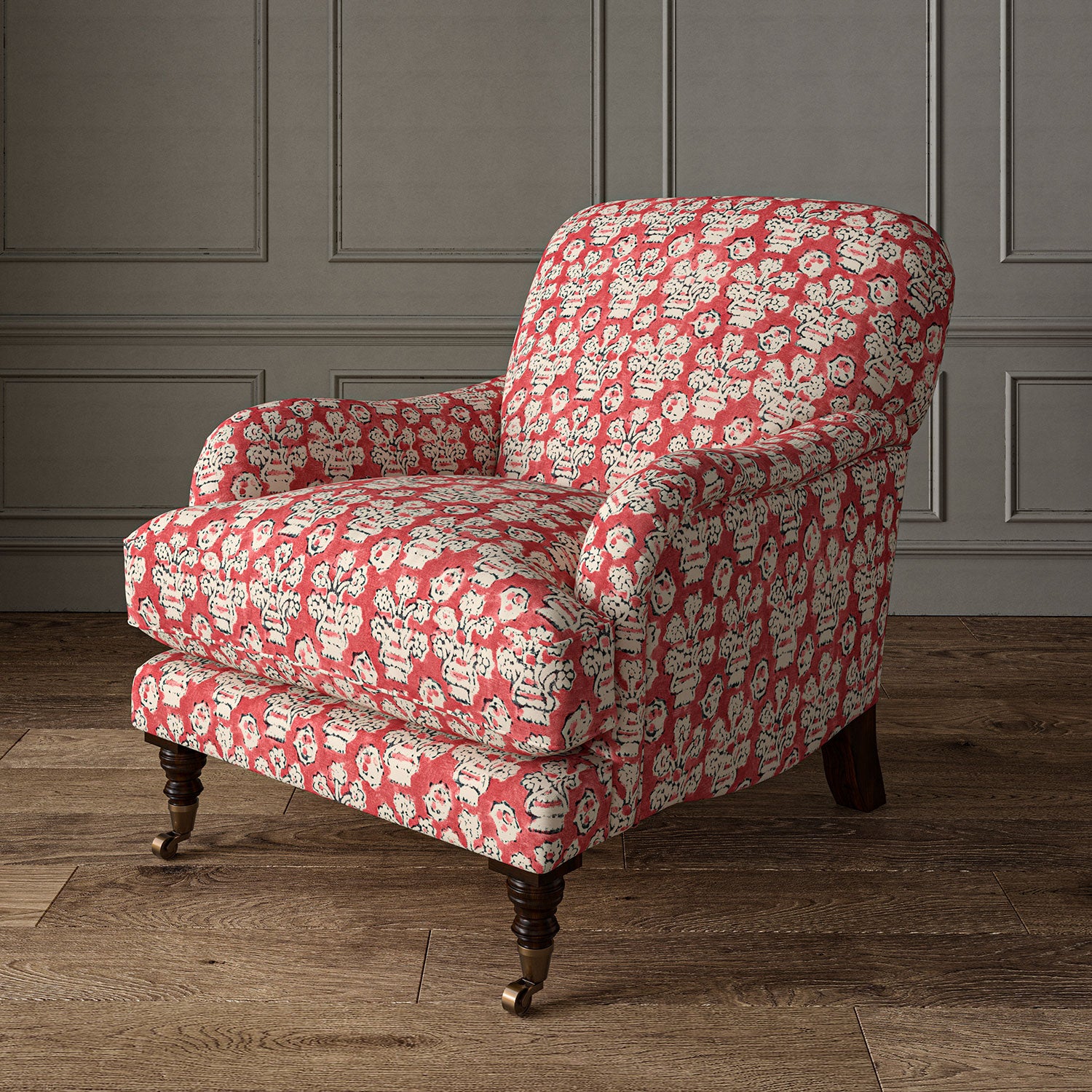 Armchair covered in a jolly printed linen fabric in red, black and cream