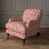 Armchair covered in a jolly printed linen fabric in red, black and cream