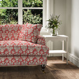 Sofa covered in a jolly printed linen fabric in red, black and cream