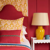 Cushion in jolly printed linen fabric in yellow, red and cream