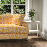 Sofa covered in a jolly printed linen fabric in yellow, red and cream