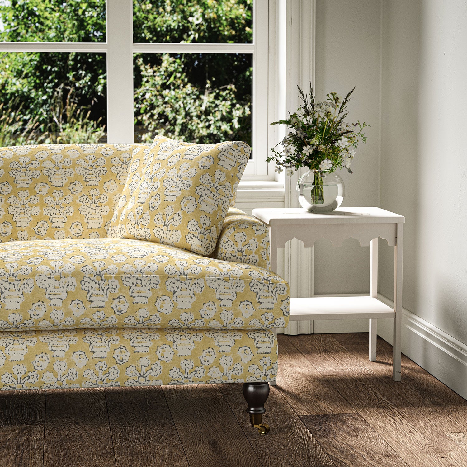 Sofa covered in a jolly printed linen fabric yellow, black and cream