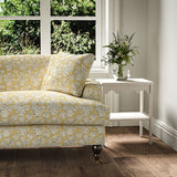 Sofa covered in a jolly printed linen fabric yellow, black and cream