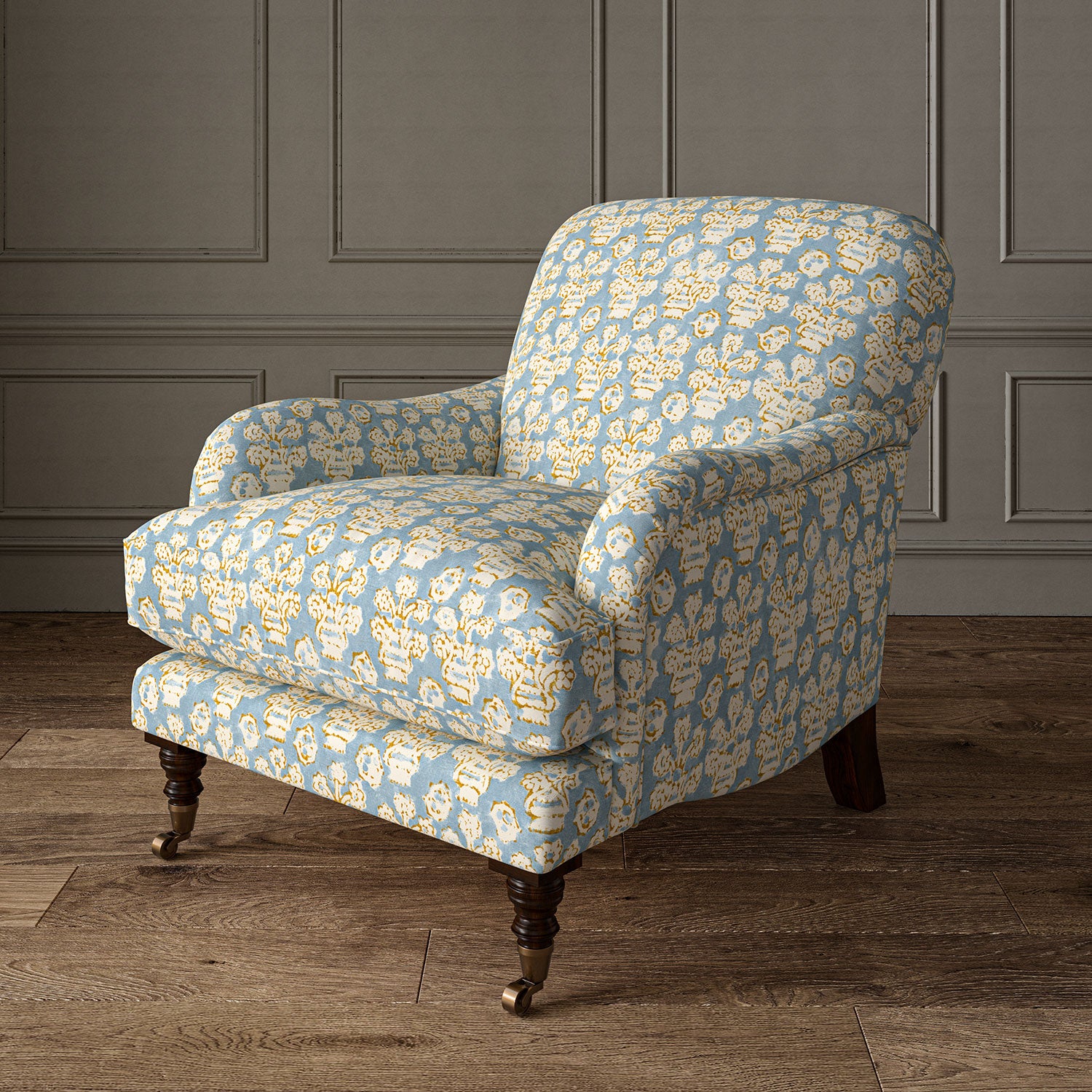 Armchair covered in a jolly printed linen fabric in blue, yellow and cream