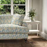 Sofa covered in a jolly printed linen fabric in blue, yellow and cream