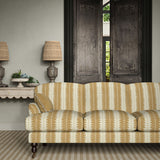 Sofa upholstered in a printed linen fabric in beige and off white, featuring a striped fern design.