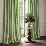 Curtains made from a printed linen fabric in green and off white, featuring a striped fern design.