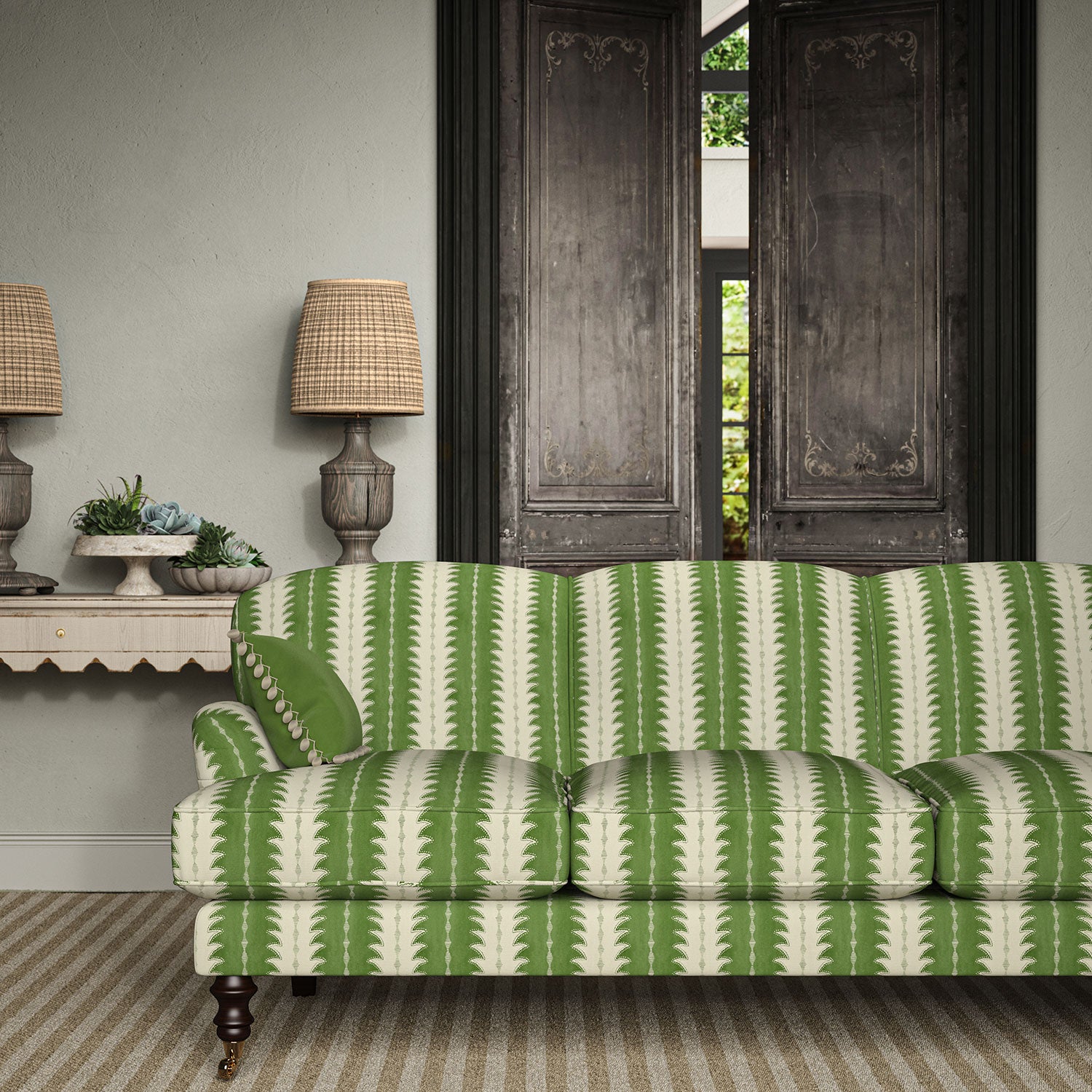 Sofa upholstered in a printed linen fabric in green and off white, featuring a striped fern design.