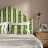 Headboard upholstered in a printed linen fabric in green and off white, featuring a striped fern design.