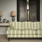 Sofa upholstered in a printed linen fabric in green and off white, featuring a striped fern design.