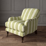 Armchair upholstered in a printed linen fabric in green and off white, featuring a striped fern design.