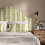 Headboard upholstered in a printed linen fabric in green and off white, featuring a striped fern design.