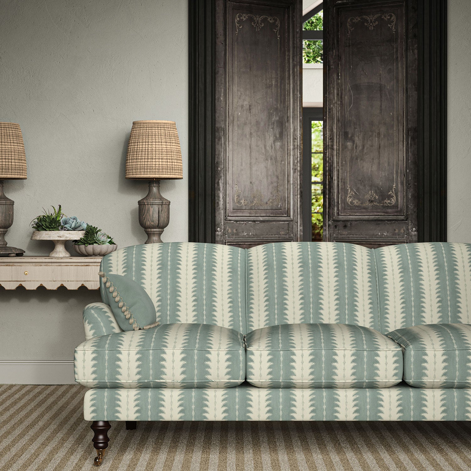 Sofa upholstered in a printed linen fabric in blue and off white, featuring a striped fern design.
