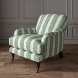 Armchair upholstered in a printed linen fabric in blue and off white, featuring a striped fern design.