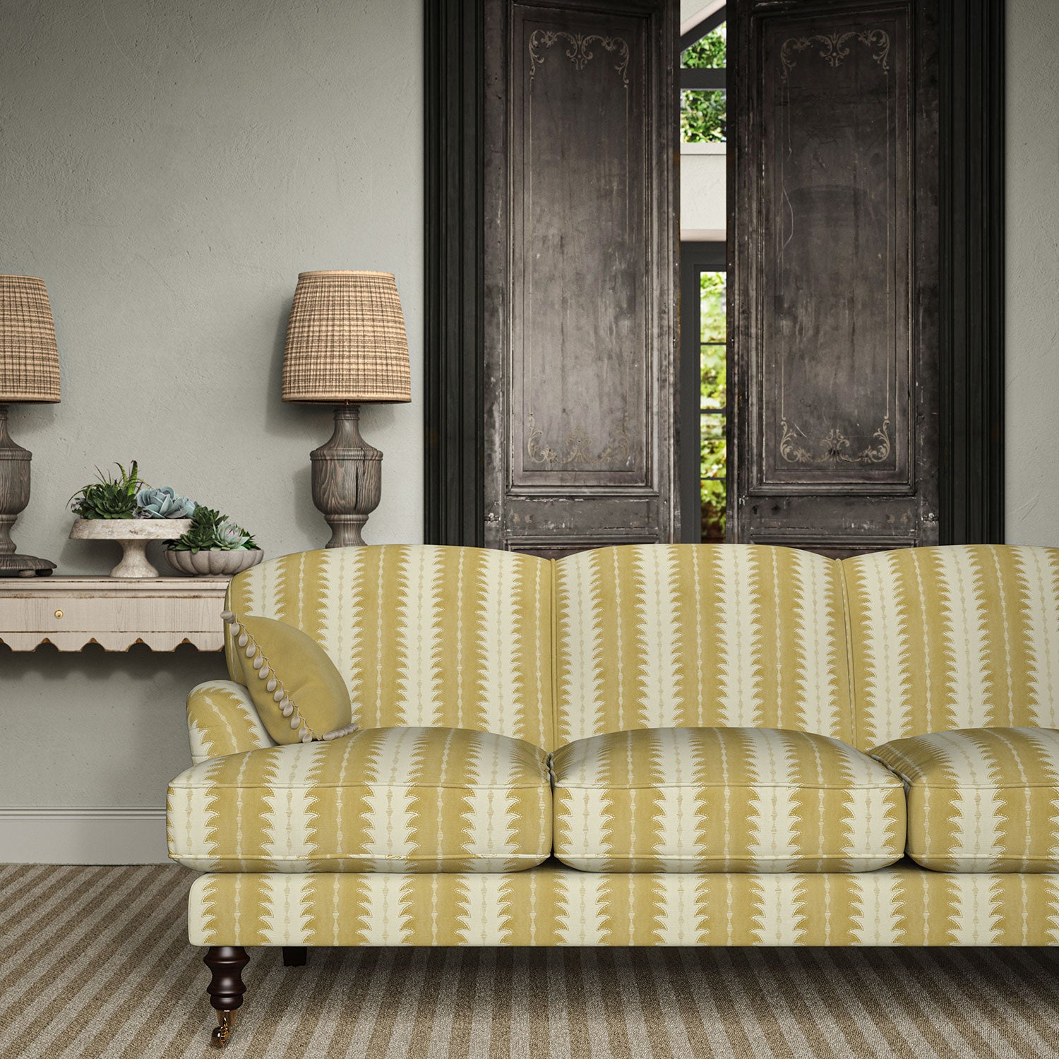 Sofa upholstered in a printed linen fabric in yellow and off white, featuring a striped fern design.