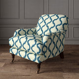 Armchair upholstered in a printed linen fabric in blue and off white featuring a mirrored ribbon pattern.
