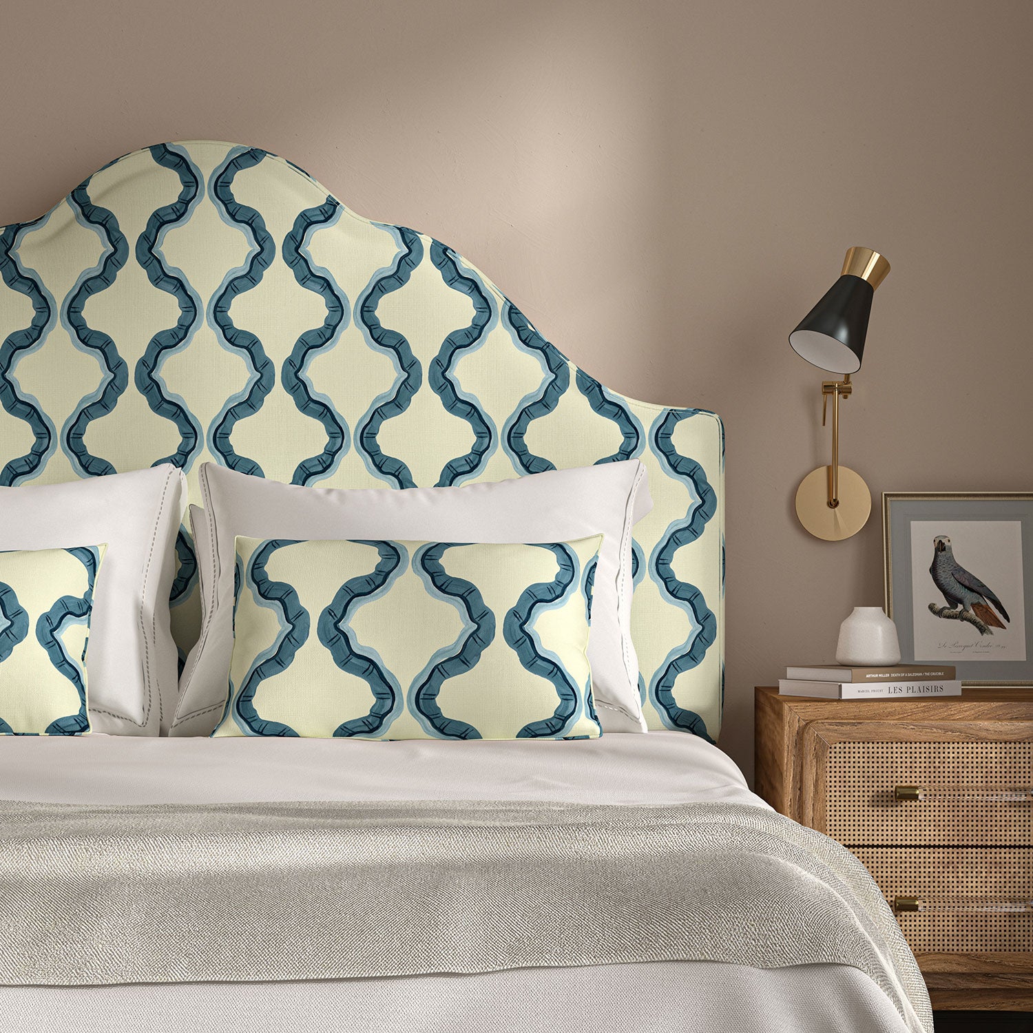 Headboard upholstered in a printed linen fabric in blue and off white featuring a mirrored ribbon pattern.