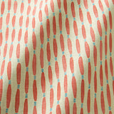 A printed linen fabric sample in orange, blue, and off white featuring a Japanese print.