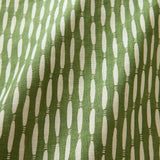 A printed linen fabric sample in green and off white featuring a Japanese print.