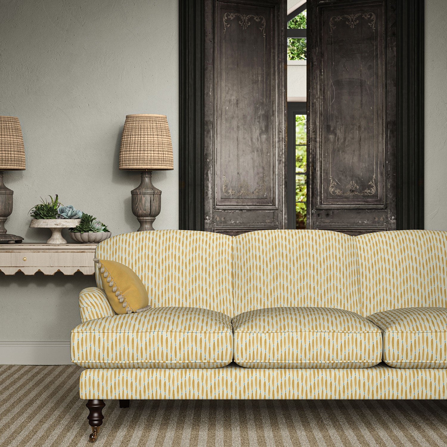 Sofa upholstered in a printed linen fabric in yellow, blue and off white featuring a Japanese print.