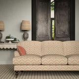 Sofa upholstered in a printed linen fabric in orange, blue and off white featuring a Japanese print.