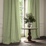 Curtains made from a printed linen fabric in green and off white featuring a Japanese print.