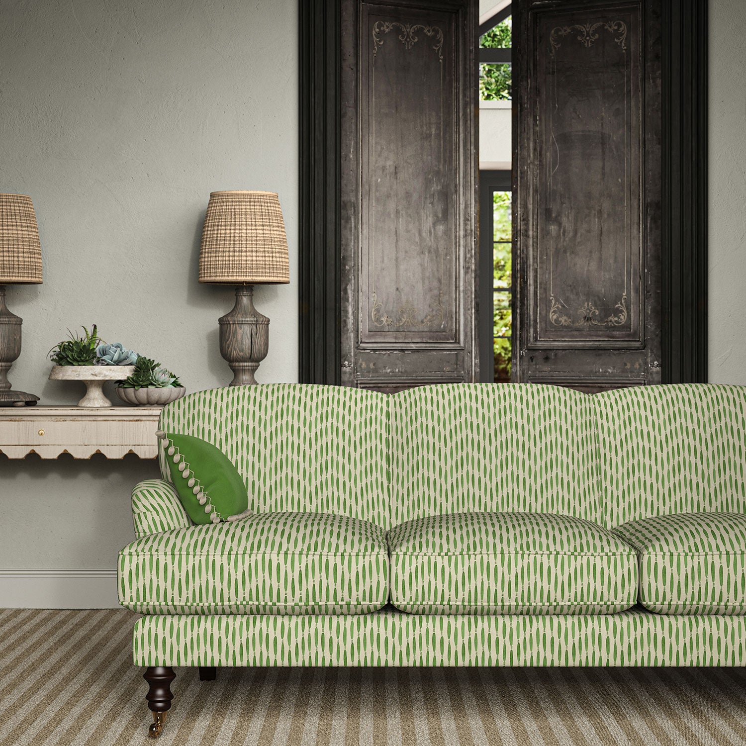 Sofa upholstered in a printed linen fabric in green and off white featuring a Japanese print.
