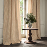 Curtains made from a printed linen fabric in orange and off white featuring a Japanese print.