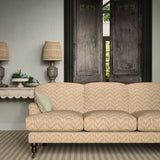 Sofa upholstered in a printed linen fabric in orange and off white featuring a Japanese print.