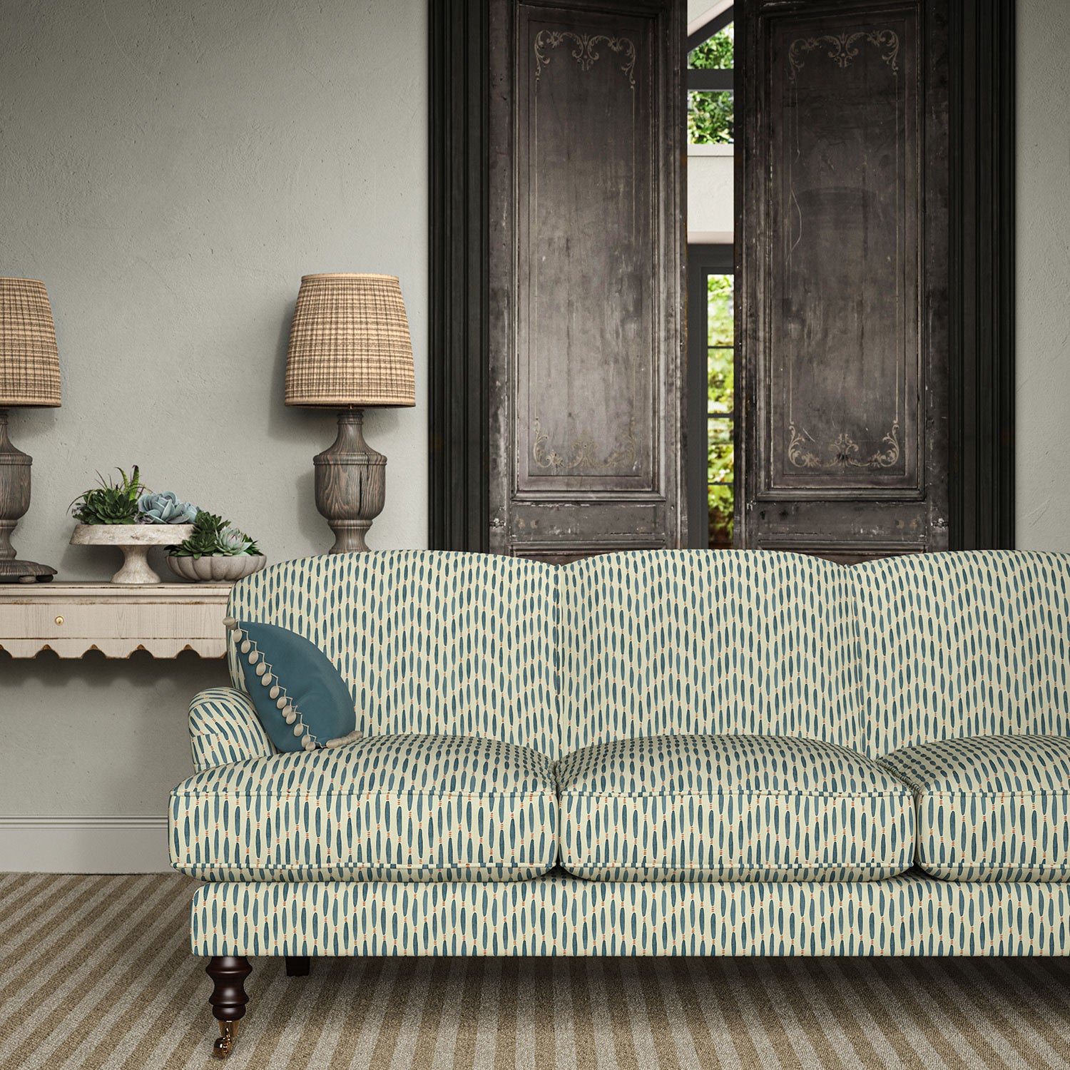 Sofa upholstered in a printed linen fabric in blue, orange, and off white featuring a Japanese print.