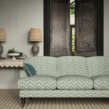 Sofa upholstered in a printed linen fabric in blue, orange, and off white featuring a Japanese print.