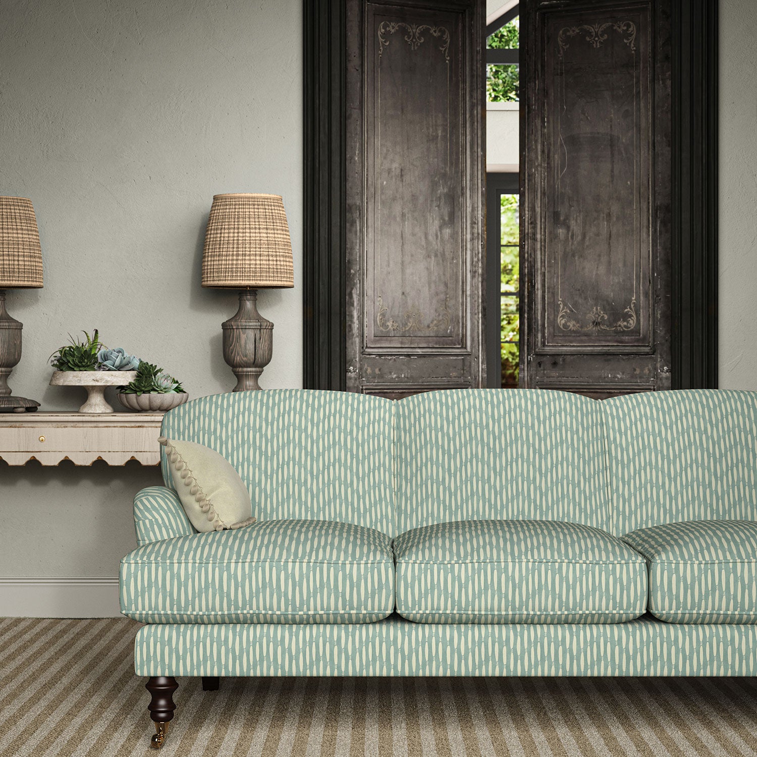 Sofa upholstered in a printed linen fabric in blue and off white featuring a Japanese print.