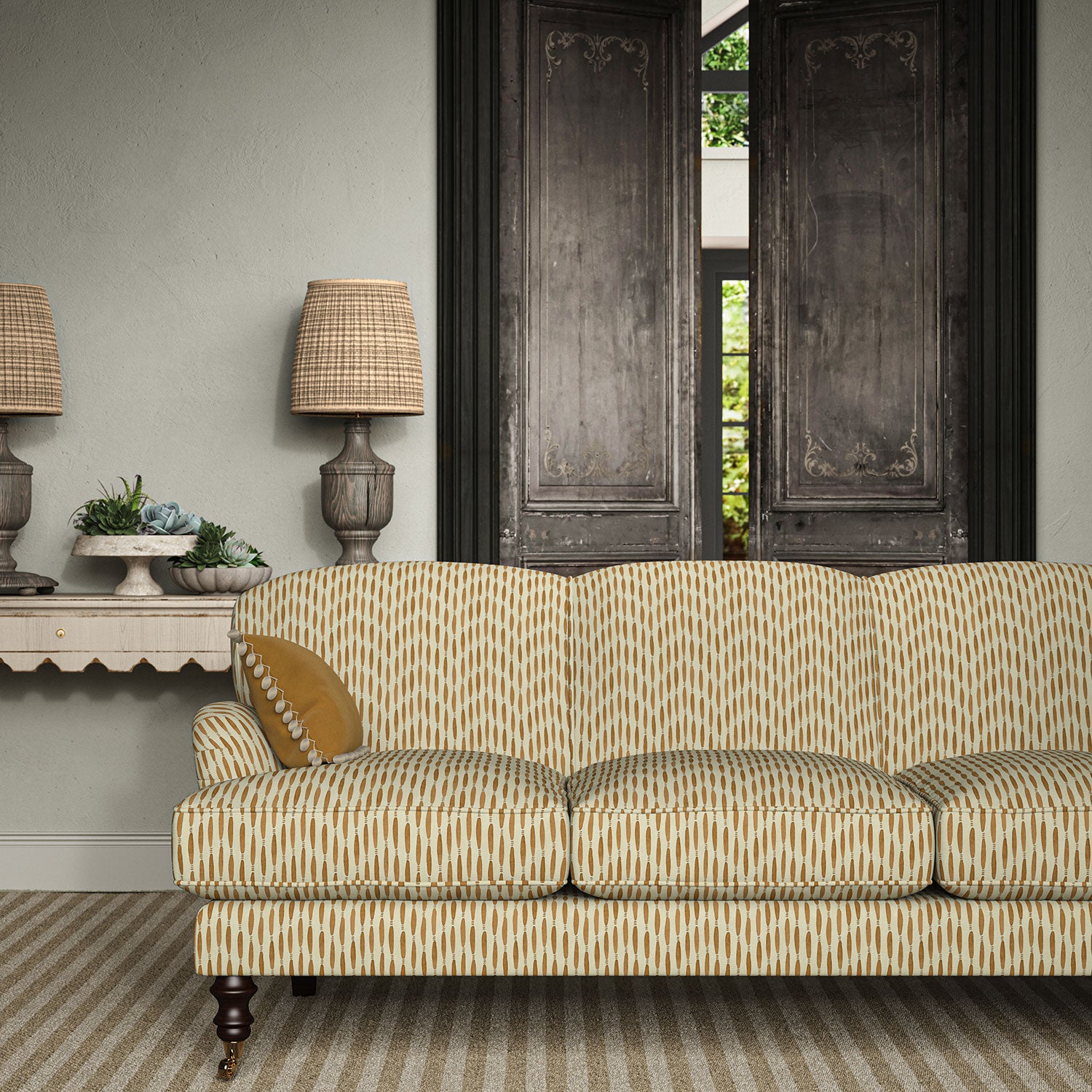 Sofa upholstered in a printed linen fabric in orange and off white featuring a Japanese print.