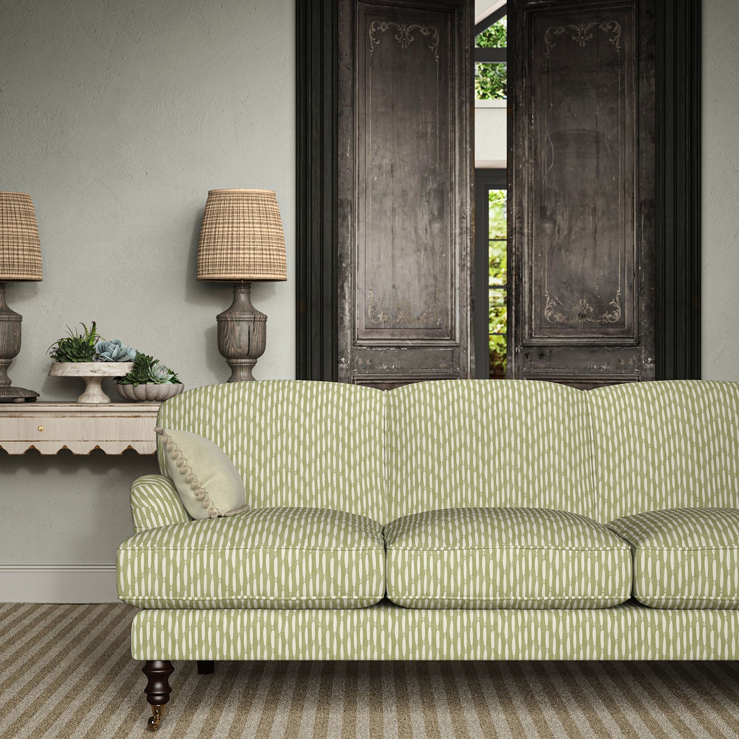 Sofa upholstered in a printed linen fabric in green and off white featuring a Japanese print.