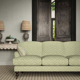 Sofa upholstered in a printed linen fabric in green and off white featuring a Japanese print.