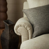 Chair upholstered in a plain luxurious woven fabric in cream.