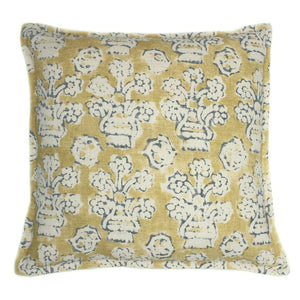 A yellow, blue and cream linen cushion with a block print pattern.