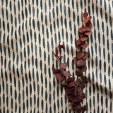 A printed linen fabric sample in blue, orange, and off white featuring a Japanese print.