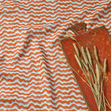 A printed linen fabric sample in red, blue and off white featuring a sound wave pattern