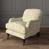 Chair upholstered in a printed linen fabric sample in yellow, blue and off white featuring a stylized coral pattern.