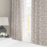 Curtains made from a printed linen fabric sample in brown, blue and off white featuring a stylized coral pattern.