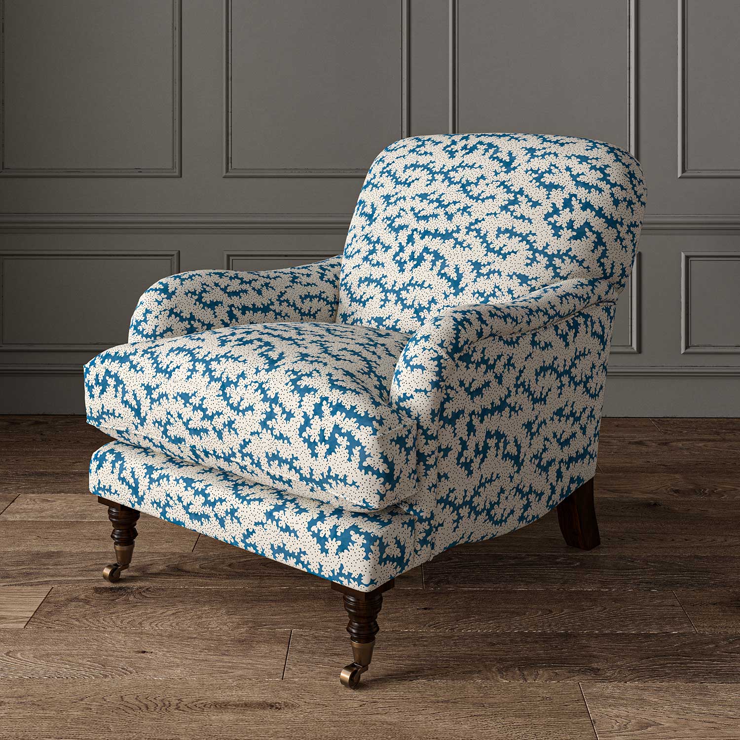 Chair upholstered in a printed linen fabric sample in blue, black and off white featuring a stylized coral pattern.