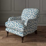 Chair upholstered in a printed linen fabric sample in blue, black and off white featuring a stylized coral pattern.