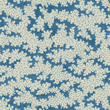 A printed linen fabric sample in blue, black and off white featuring a stylized coral pattern.