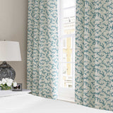 Curtains made from a printed linen fabric sample in blue, black and off white featuring a stylized coral pattern.