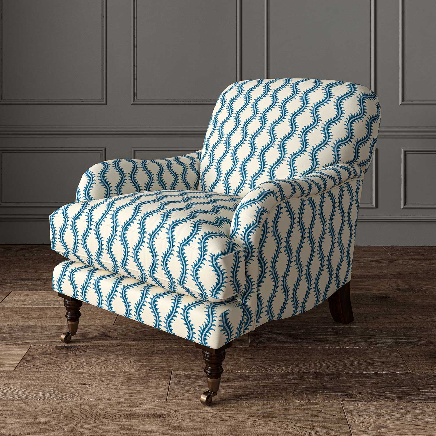 Chair upholstered in a printed linen fabric sample in blue and off white featuring a stylized fern pattern.