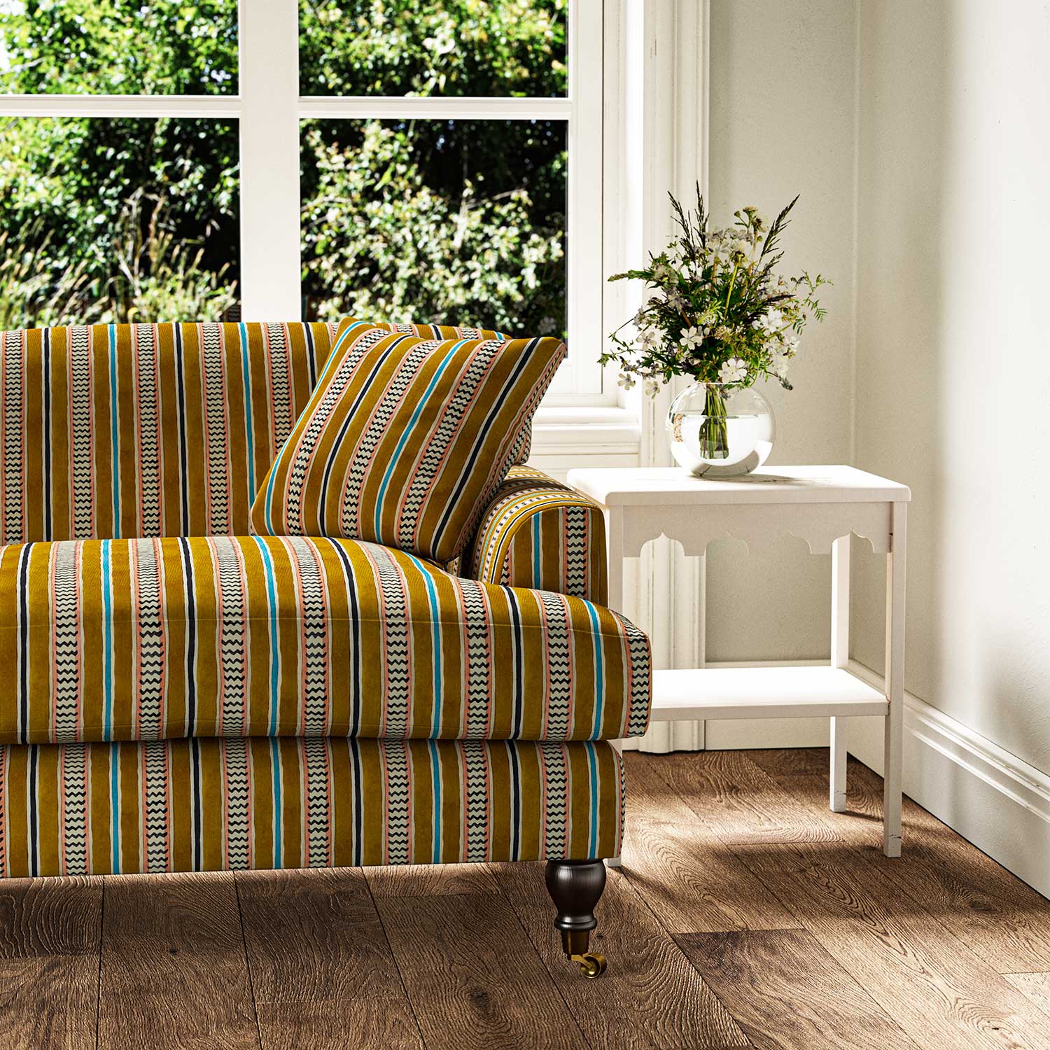 Sofa in a multicoloured printed linen fabric featuring stripes, wavy edges and zigzags.