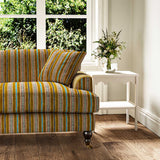 Sofa in a multicoloured printed linen fabric featuring stripes, wavy edges and zigzags.